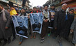 Kashmiri Shiite muslims carry pictures of killed Iranian general Qassem Soleimani as they...