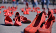 A group of women join at Zocalo to take part during a protest with red-painted shoes to ce...