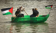 Young Palestinians on their boat made from remnants of empty plastic bottles inside the po...