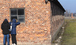 A couple of tourists checking the inside of the camp building inside Auschwitz II-Birkenau...