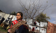 A Palestinian girl hangs out the laundry during heavey rains in Beit Lahia in the northern...