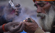 A Hindu Sadhu or Holy Man prepare  to smoke marijuana in a Chillim during Maha Shivaratri...