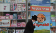 An Ultra-Orthodox Jew walks past a children toys shop in Jerusalem Center.On Monday, Febr...