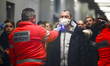 Health personnel monitors body temperature of passengers who arrived in a flight from Mila...