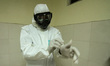 A health worker is seen wearing protective gear when inspecting quarantine room equipment...