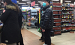 Man wearing a face mask at a grocery store to protect from the novel coronavirus (COVID-19...