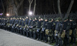 Policemen stand guard ahead of a rally outside the Russian embassy to mark the Volunteer D...