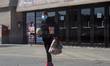 Woman wearing a face mask to protect her from the novel coronavirus (COVID-19) at a grocer...
