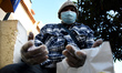 A man wears a mask and protective gloves in Lisbon, April 3, 2020. The Portuguese governme...