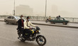 A man wearing face mask rides a motorcycle during a sandstorm in Cairo, Egypt, 05 April 20...