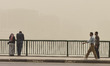  People stand and walking on a bridge during a sandstorm in Cairo, Egypt, 5 April 2020. 