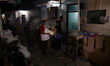 Local officers distribute the basic needs aids from government to residents, ahead of the...