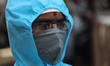 A healthcare worker wearing protective suit and face mask looks on in Mumbai, India on Apr...