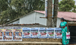 Tamil woman stands by the roadside in the small village of Pooppara (Poopara), Idukki, Ker...