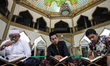 People are seen reading the Koran at night during the holy month of Ramadan at the Mosque...