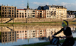 A woman in protective face mask is seen enjoying an outdoor walk by a river Vistula during...