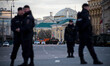 Policemen guarding the road leading towards the Red Square as a military personel carrier...