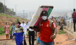 A man wear face mask ahead of police check point in compliance with the state directive to...