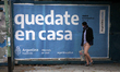 A woman wearing a protective mask waits at a bus stop in Buenos Aires, Argentina, on May 1...