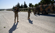 Turkish forces secure a section of the M4 highway to protect joint Russian-Turkish patrol...