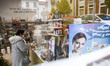 A shop assistant cares for a customer at her natural food store, in Norena, Spain, on May...