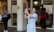A nurse claps her hands outside Chelsea and Westminster Hospital to take part in the weekl...