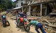 Kids are playing on the motor bike in front of their destroyed house. Sindhupal Chowk, Nep...