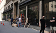 Workers board up windows of establishment to as anti-looting measures. Protestors rally ag...