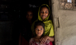 Three sisters of a snake charmer's family pose for the camera in smiling face in Shunamgon...