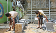 Workers chisel stone during re-construction of the Raja Gopuram tower of the Arul Eswari M...