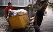 Residents crossing the flood water cause by rob as they do their activities in North Jakar...