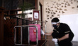 The Margo Hotel crews cleans the guest lugages with disinfectant liquid as the one of the...