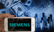 In this illustration is displayed on a smartphone's screen the company logo of Siemens, wh...