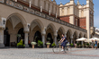 A woman is seen riding a bicycle on a Main Market in front of Sukiennice as Poles enjoy fi...