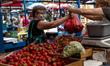 A woman in protective face mask is seen buing strowberries as Poles enjoy first hot day af...