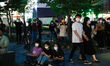 Pro-democracy supporters hold banner and shout slogans against the restricting freedom of...