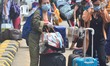Nagaland returnees stand in queue to board a Government bus to be deported to their respec...