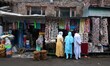 Customers bargain outside a handicraft shop in Srinagar, Kashmir on June 13, 2020. Markets...
