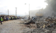 Officials Lagos State Emergency Management demolishing the remains of the building, after...