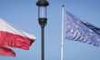 The flags of the city of Gdansk, Poland and the EU are seen near an old, gas fueled street...