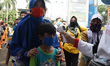   Health workers conduct rapid tests on residents in the yard of a mall in Kramat Jati, on...