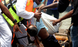 Rescue workers carry bodies of victims following the Launch capsized in Buriganga River in...