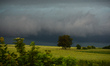 A view of a dark sky and farming fields near Skala during rainy weather. The month of Jun...