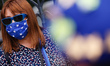 An anti-Brexit activist wearing a face mask resembling the EU flag demonstrates outside th...