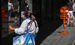 A woman asks for the money on the street in Brussels, Belgium, July 23, 2020. 