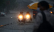 Indian People during a Heavy Monsoon Rain shower in Ajmer, Rajasthan, India on 24 July 202...