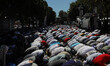 People wait for the first official Friday prayers to start outside Hagia Sophia Mosque on...