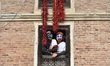 Nepalese devotees glancing from a traditional window during the saparu parade at Khokona,...