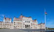 Hungarian flag on the wind in front of Hungarian Parliament Building is seen in Budapest,...