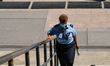 A USPS worker is seen in front of The James A. Farley Building, it is the main United Stat...
